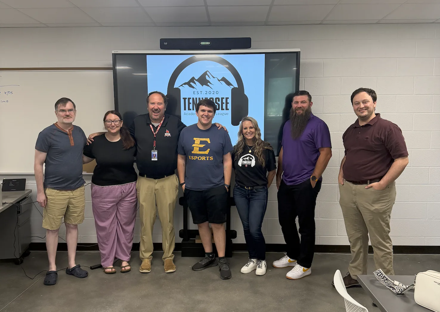 Coaches and TAEL leaders standing in front of the TAEL logo after finalizing the 2026-2027 season structure
